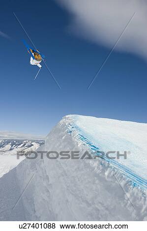 Stock Photo - A downhill skier jumping. Fotosearch