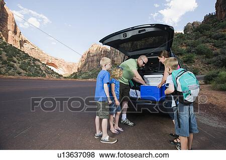 Stock Photo - A family on vacation at Red Rock unloading a van. Fotosearch