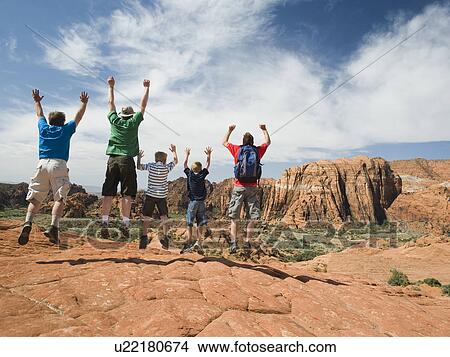 A father with kids at Red Rock jumping View Large Photo Image Picture - A father with kids at Red Rock jumping. Fotosearch