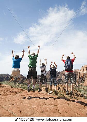 A father with kids at Red Rock jumping View Large Photo Image Stock Photograph - A father with kids at Red Rock jumping. Fotosearch