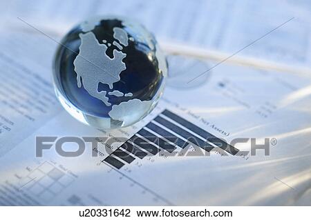 Stock Image - A globe on business papers. Fotosearch
