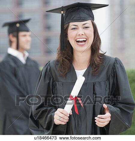 Stock Image - A graduate holding a diploma. Fotosearch