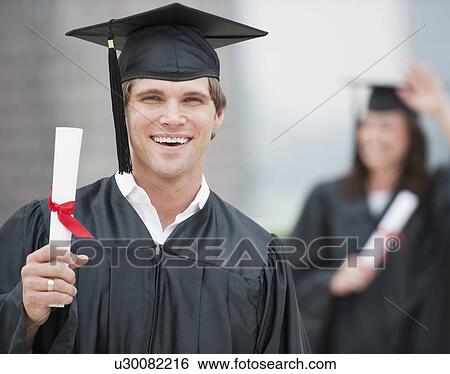 A graduate holding a diploma View Large Photo Image Stock Photograph - A graduate holding a diploma. Fotosearch