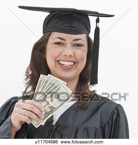 A graduate holding money View Large Photo Image Stock Photograph - A graduate holding money. Fotosearch