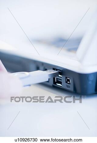 A hand plugging in a universal serial bus View Large Photo Image Stock Image - A hand plugging in a universal serial bus. Fotosearch