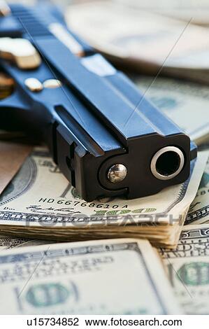 A handgun on stacks of money View Large Photo Image Stock Image - A handgun on stacks of money. Fotosearch
