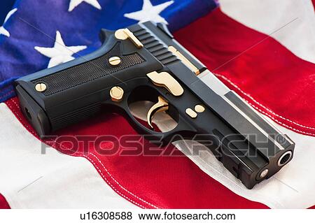 A handgun on the American flag View Large Photo Image Stock Photo - A handgun on the American flag. Fotosearch
