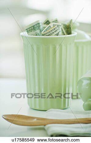 Stock Photo - A jar with money in it. Fotosearch
