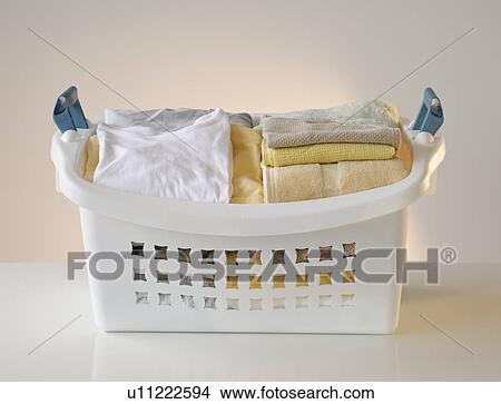 A laundry basket full of clothes View Large Photo Image Picture - A laundry basket full of clothes. Fotosearch
