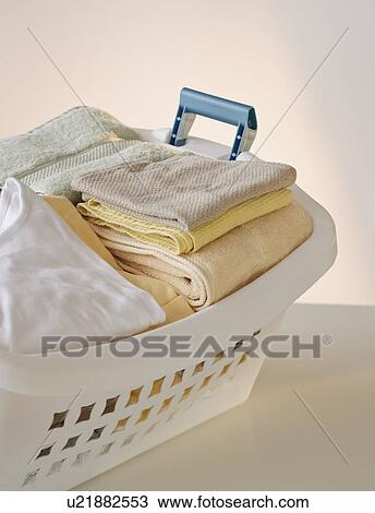 A laundry basket full of clothes View Large Photo Image Stock Image - A laundry basket full of clothes. Fotosearch