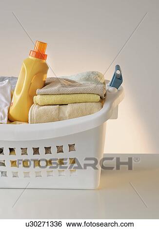 A laundry basket full of clothes View Large Photo Image Stock Photograph - A laundry basket full of clothes. Fotosearch