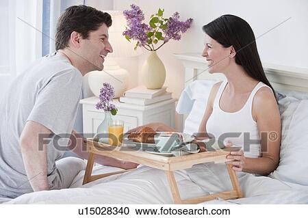 A man bringing a woman breakfast in bed View Large Photo Image Stock Image - A man bringing a woman breakfast in bed. Fotosearch