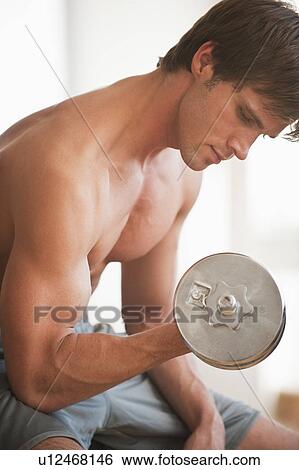 A man lifting weights View Large Photo Image Stock Photograph - A man lifting weights. Fotosearch