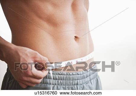 A man measuring his abdomen View Large Photo Image Stock Image - A man measuring his abdomen. Fotosearch