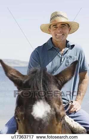 A man riding a horse View Large Photo Image Stock Photo - A man riding a horse. Fotosearch