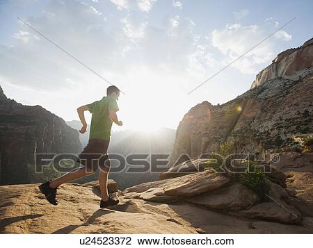 Stock Image - A man running at Red Rock. Fotosearch