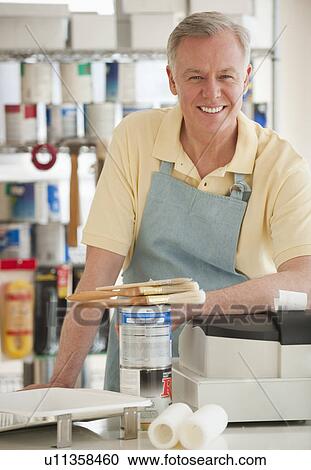 Stock Image - A man working at a paint store. Fotosearch