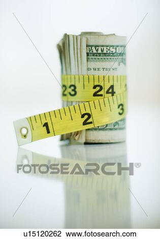 Stock Image - A measuring tape around bank notes. Fotosearch