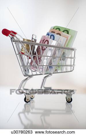 A miniature shopping cart with bank notes and coins View Large Photo Image Stock Image - A miniature shopping cart with bank notes and coins. Fotosearch