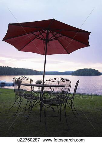 Stock Photo - A patio set by a lake. Fotosearch
