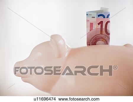 A piggy bank with bank notes in it View Large Photo Image Picture - A piggy bank with bank notes in it. Fotosearch