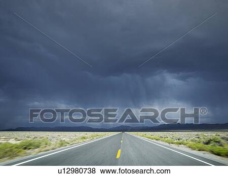 Stock Photo - A scenic and empty road. Fotosearch