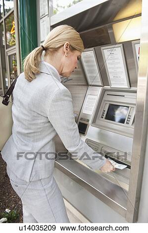 A woman at an automatic teller View Large Photo Image Stock Photo - A woman at an automatic teller. Fotosearch