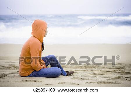Stock Photo - A woman at the beach. Fotosearch