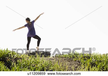 A woman dancing outdoors View Large Photo Image Stock Photo - A woman dancing outdoors. Fotosearch