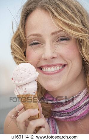 A woman eating ice cream View Large Photo Image Stock Image - A woman eating ice cream. Fotosearch