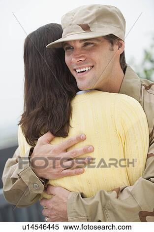 A woman hugging a military officer View Large Photo Image Stock Photography - A woman hugging a military officer. Fotosearch