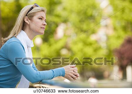 Stock Image - A woman in the park. Fotosearch