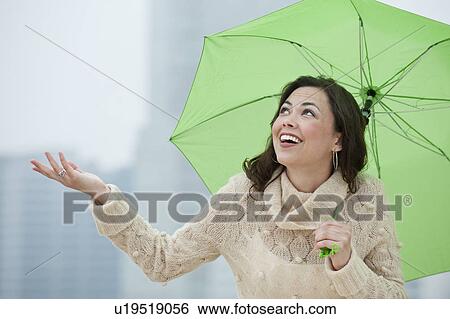 A woman outdoors in the rain View Large Photo Image Stock Photograph - A woman outdoors in the rain. Fotosearch