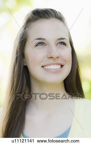 Stock Image - A woman outdoors smiling. Fotosearch