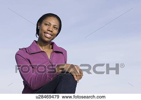 A woman outdoors smiling View Large Photo Image Stock Photo - A woman outdoors smiling. Fotosearch