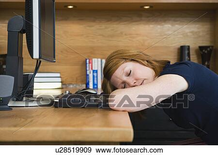 A woman sleeping in a home office View Large Photo Image Stock Photo - A woman sleeping in a home office. Fotosearch