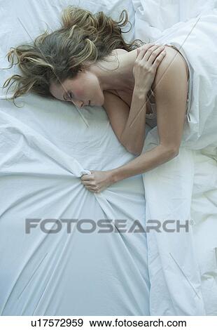 A woman sleeping in bed View Large Photo Image Stock Photo - A woman sleeping in bed. Fotosearch