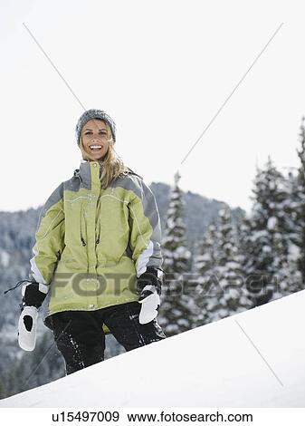 A woman standing in the snow View Large Photo Image Stock Photo - A woman standing in the snow. Fotosearch