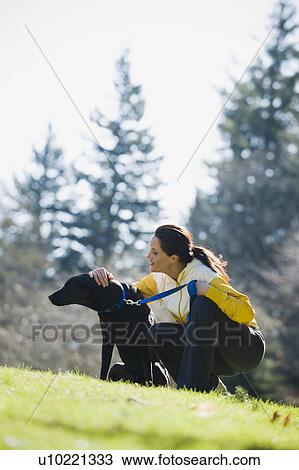A woman with a dog outdoors View Large Photo Image Stock Image - A woman with a dog outdoors. Fotosearch