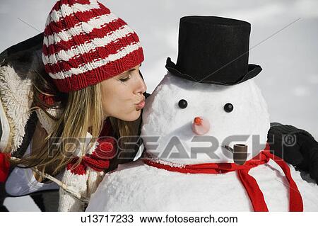 Stock Image - A woman with a snowman. Fotosearch