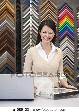 A woman working at a frame store View Large Photo Image Stock Image - A woman working at a frame store. Fotosearch