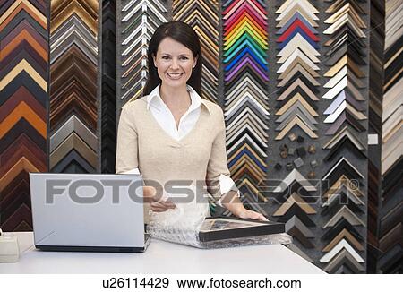 A woman working at a frame store View Large Photo Image Stock Photo - A woman working at a frame store. Fotosearch