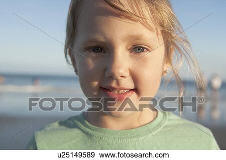 Stock Photo - A young girl at the beach. Fotosearch