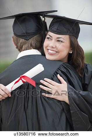 A young woman and young man graduating View Large Photo Image Stock Photograph - A young woman and young man graduating. Fotosearch