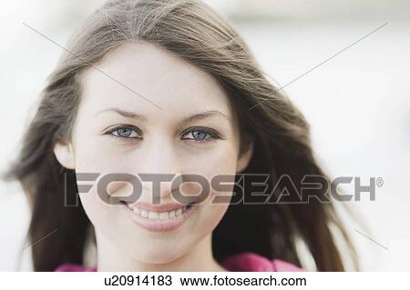 A young woman outdoors smiling View Large Photo Image Stock Image - A young woman outdoors smiling. Fotosearch