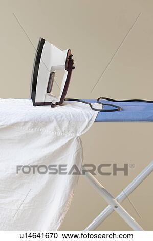 Stock Image - An ironing board with an iron. Fotosearch