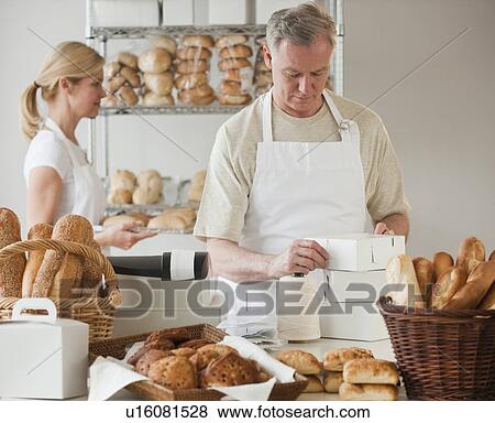 Bakers in a bakery View Large Photo Image Stock Photo - Bakers in a bakery. Fotosearch