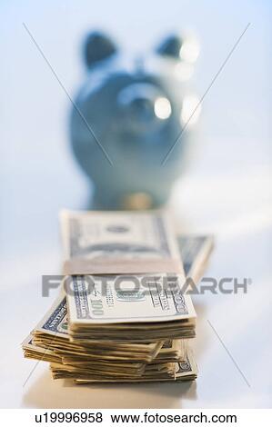 Bank notes and coins by a piggy bank View Large Photo Image Stock Photo - Bank notes and coins by a piggy bank. Fotosearch