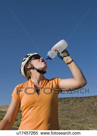 Stock Photography - Biker drinking water. Fotosearch
