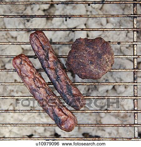 Burnt wieners and a burger on a barbeque View Large Photo Image Stock Photograph - Burnt wieners and a burger on a barbeque. Fotosearch